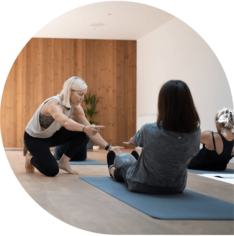 Lisa teaching a small group mat Pilates class in the studio