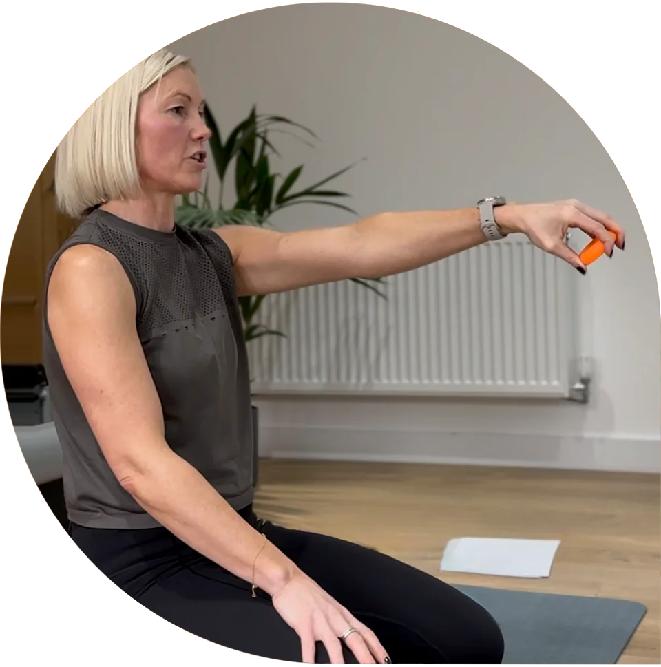 Lisa explaining a movement during a Pilates workshop